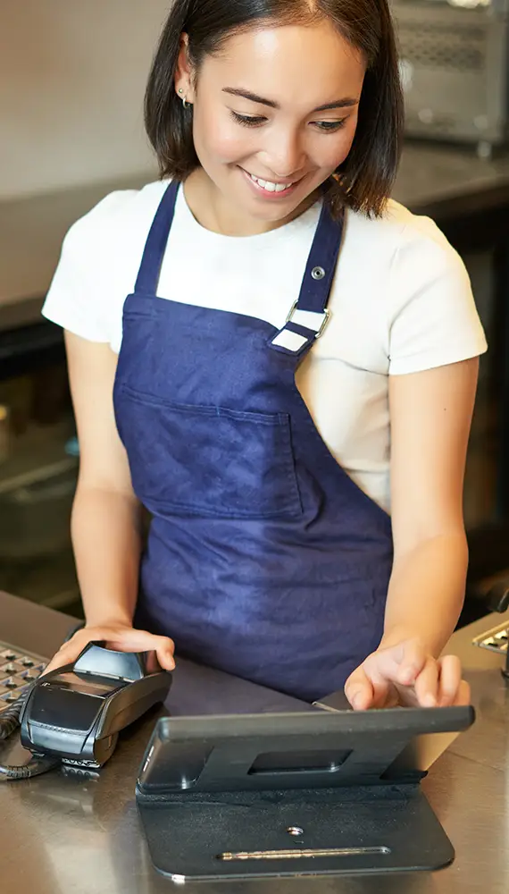 Hospitality professional using a digital tablet
