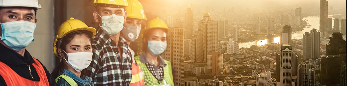 Construction professionals smiling while working on site.